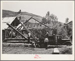 Ola, Idaho. FSA (Farm Security Administration) Ola self-help cooperative. A member places a hook on a log