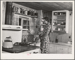Ola, Idaho. FSA (Farm Security Administration) Ola self-help cooperative. Wife and child of a member in the kitchen of their home