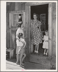 Ola, Idaho. FSA (Farm Security Administration) Ola self-help cooperative. Wife of a member talks with her visiting neighbor who is also a member of the cooperative. The mother and child standing in the doorway are the same as in photograph 21657-C taken