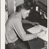 Ola, Idaho. FSA (Farm Security Administration) Ola self-help cooperative. The treasurer works on the books in the office