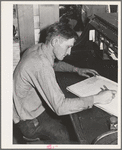 Ola, Idaho. FSA (Farm Security Administration) Ola self-help cooperative. The treasurer works on the books in the office