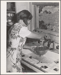 Ola, Idaho. The wife of a member of the Ola self-help cooperative washing berries. Running water in the house is a very recent improvement for this family