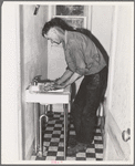 Ola, Idaho. A member of the Ola self-help cooperative in the bathroom, a recent improvement in his home of which he is proud