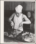 Rupert, Idaho. Former CCC (Civilian Conservation Corps) camp now under FSA (Farm Security Administration) management. Chef carving meat for supper at the community mess hall of the Japanese-Americans