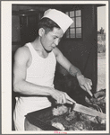 Rupert, Idaho. Former CCC (Civilian Conservation Corps) camp now under FSA (Farm Security Administration) management. Chef carving meat for supper at the community mess hall of the Japanese-Americans