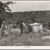 Camp of migrant agricultural day laborers who moved their goods along the road in this push cart. Camp is near Vian, Oklahoma, Sequoyah County