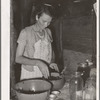 Wife of itinerant statue maker and agricultural day laborer canning blackberries. Poteau Creek near Spiro, Oklahoma, Sequoyah County