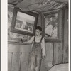 Indian boy between portraits of his ancestors. Near Sallisaw, Oklahoma