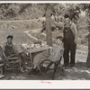 Farmers visiting an old couple living in tent outside of Sallisaw, Oklahoma. Sequoyah County