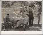 Farmers visiting an old couple living in tent outside of Sallisaw, Oklahoma. Sequoyah County