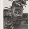 Rear of migrant's truck with dog underneath it. Getting ready to leave for California. Near Muskogee, Oklahoma