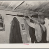 Moving the rifle which was placed on the wall before leaving for California from Muskogee, Oklahoma