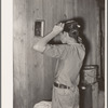 Migrant boy combing his hair at his home near Muskogee, Oklahoma