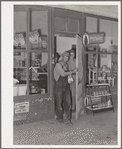 Migrant family emerging from grocery store where they have stopped along the road in order to buy bread and potatoes, which will form the basis for their noonday meal. Near Henryetta, Oklahoma