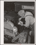Elmer Thomas, migrant to California, pouring oil into engine preparatory for departure to California. Oklahoma