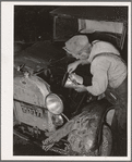 Elmer Thomas, migrant to California, pouring oil into engine preparatory for departure to California. Oklahoma