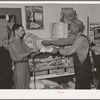 Head of migrant family buying loaf of bread in grocery store of small town near Henryetta, Oklahoma