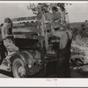 Getting ready to leave for California. Putting the cage in place on rear of truck. Near Muskogee, OklahomaGetting ready to leave for California. Putting the cage in place on rear of truck. Near Muskogee, Oklahoma