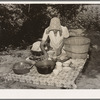 Packing dishes and silverware preparatory to departure for California from Muskogee, Oklahoma