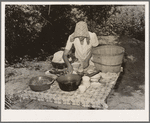 Packing dishes and silverware preparatory to departure for California from Muskogee, Oklahoma