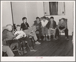 Children singing at boys' camp fireside meeting. El Porvenir, New Mexico