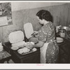 Proprietress of family style restaurant dishing up food. Muskogee, Oklahoma