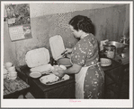 Proprietress of family style restaurant dishing up food. Muskogee, Oklahoma