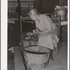 Wife of tenant farmer living near Muskogee picking over tomatoes before peeling for canning. Refer to general caption number 20