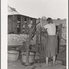 Daughter of tenant farmer living near Muskogee, Oklahoma, pumping water out of tub. See general caption number 20