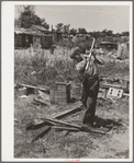 Boy living in Mays Avenue camp, Oklahoma City, Oklahoma, chopping wood. Refer to general caption no. 21