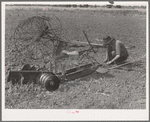 Son of tenant farmer near Muskogee, Oklahoma, working on disc harrow with rake in background. Refer to general caption no. 20