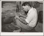 Resident of Mays Avenue camp taking out a piece of glass from boy's foot. Oklahoma City, Oklahoma