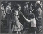 Woman and children among the crowd at a New York Shakespeare Festival performance of The Taming of the Shrew