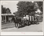 Water peddler in community camp. Oklahoma City, Oklahoma. He is paid fifteen cents a barrel for delivering water to the shack homes