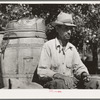 Water peddler in community camp. Oklahoma City, Oklahoma. He is paid fifteen cents a barrel for delivering water to the shack homes