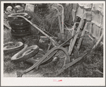 Old plows and wornout tires. Testimonial to the sources of the residents of the community camp. Oklahoma City, Oklahoma