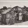 Family in front of shack home near Mays Avenue camp. Oklahoma City, Oklahoma. He had farmed near Norman, Oklahoma, until a year previously