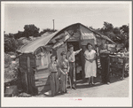 Family in front of shack home near Mays Avenue camp. Oklahoma City, Oklahoma. He had farmed near Norman, Oklahoma, until a year previously