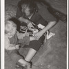 Mother bandaging toe of her son which was cut in debris of Mays Avenue camp. Oklahoma City, Oklahoma