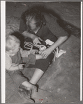 Mother bandaging toe of her son which was cut in debris of Mays Avenue camp. Oklahoma City, Oklahoma