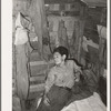 Boy in corner of shack home near Mays Avenue. Oklahoma City, Oklahoma