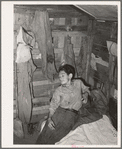 Boy in corner of shack home near Mays Avenue. Oklahoma City, Oklahoma