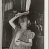 Little girl combing hair. She lives in camp near Mays Avenue. Oklahoma City, Oklahoma