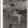 Tenant farmer looking through the mail. Near Muskogee, Oklahoma