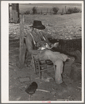 Tenant farmer looking through the mail. Near Muskogee, Oklahoma