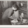 Resident of Mays Avenue camp making biscuits. Oklahoma City, Oklahoma