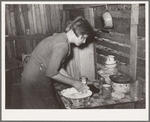 Resident of Mays Avenue camp making biscuits. Oklahoma City, Oklahoma