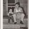 Oil field truck driver and his son sitting on front porch. Seminole, Oklahoma