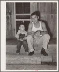Oil field truck driver and his son sitting on front porch. Seminole, Oklahoma