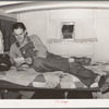 Oil field worker in his trailer home reading a letter. Seminole, Oklahoma